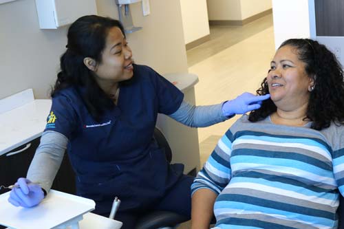 A dentist with a patient at the Culinary Health Center